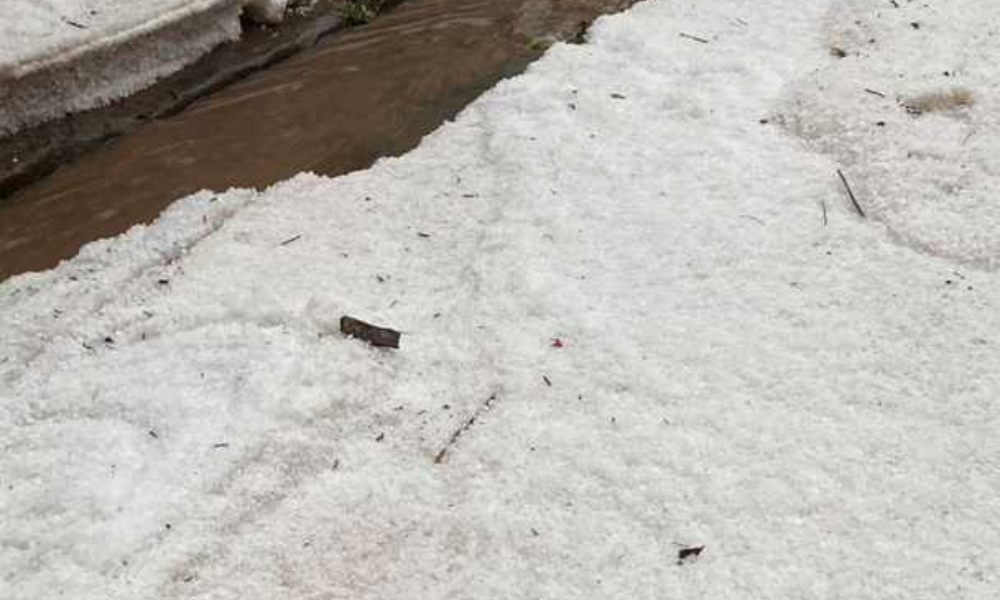 Chuva de granizo cria camadas de gelo em rua de cidade mineira